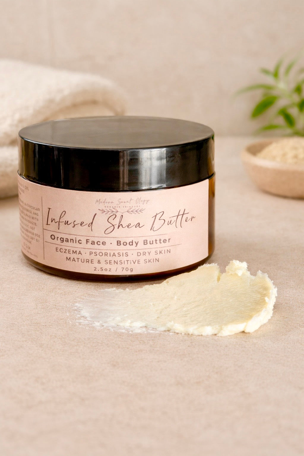Infused Shea Body Butter made with raw shea butter imported from Ghana, rose oil, and in-house calendula oil. Creamy texture shown in a jar on a neutral background, formulated for eczema-prone and sensitive skin.