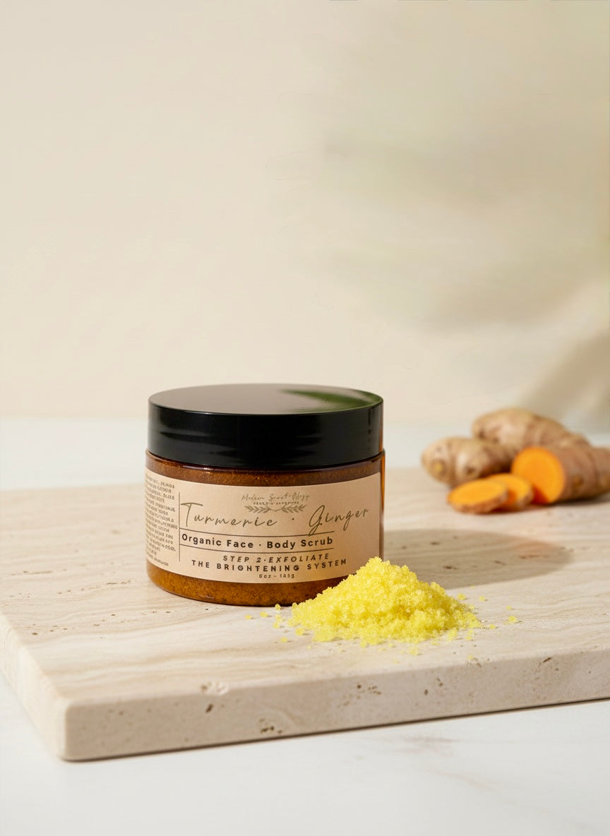 Turmeric & Ginger Radiance Renewal Set: Includes a handcrafted exfoliating scrub, infused with turmeric, ginger, and sweet orange essential oils arranged on a neutral background.
